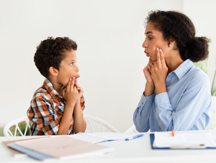 A child participates in speech therapy.